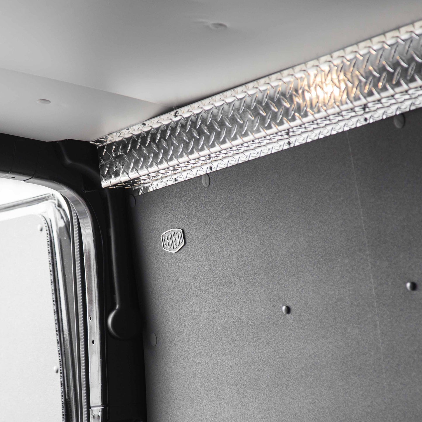 Aluminum top sill covering the join between composite wall liner and ceiling liner