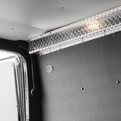 Aluminum top sill covering the join between composite wall liner and ceiling liner