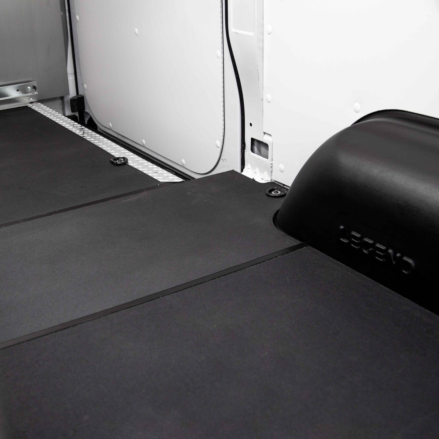 Image showing H tracks joining StabiliGrip flooring in a vehicle interior.